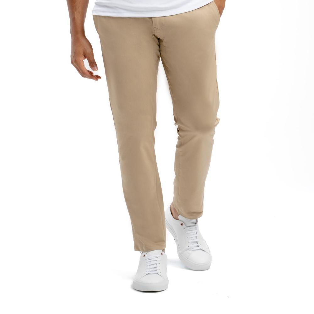 Beige pants worn by a person on a white background